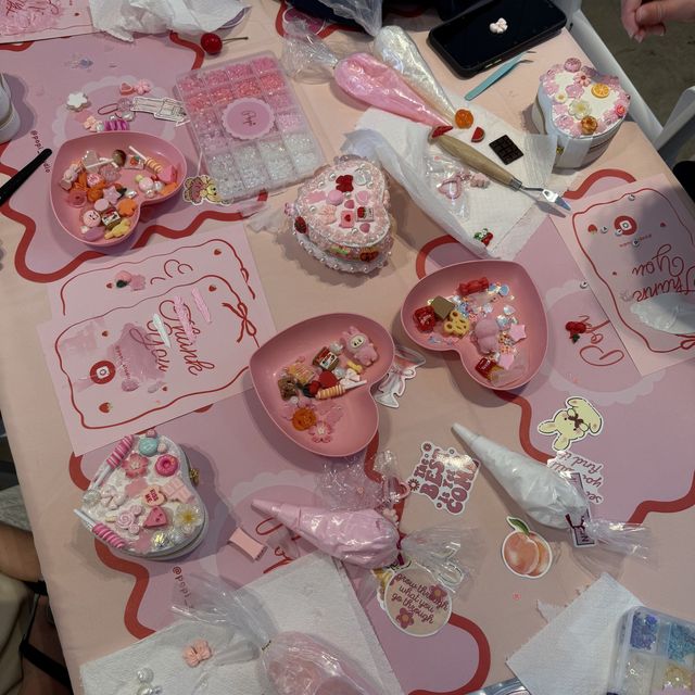 An adults decoden party in progress with heart jewellery boxes, charm trays and piping bags